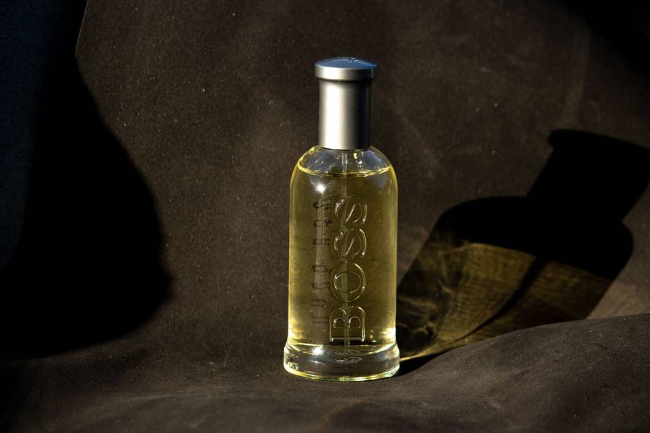 Minimalist bottle of premium aftershave on a marble surface with subtle steam rising, clean grooming tools nearby